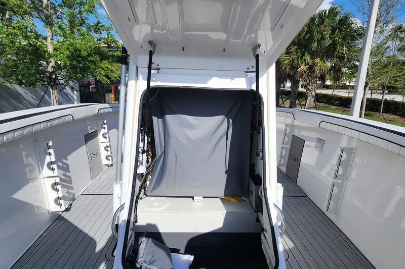 Slide: The Image of 2022 Yamaha 255 FSH Sport E boat interior with open storage compartment. - 23