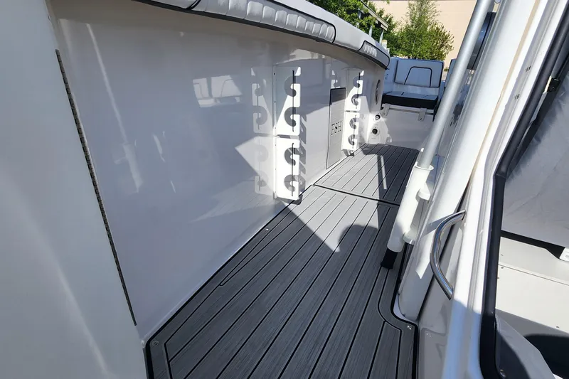 Slide: The Image of 2022 Yamaha 255 FSH Sport E boat interior with sleek deck and rod holders. - 24