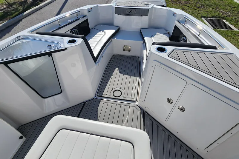 Slide: The Image of 2022 Yamaha 255 FSH Sport E boat interior with seating and storage compartments. - 27