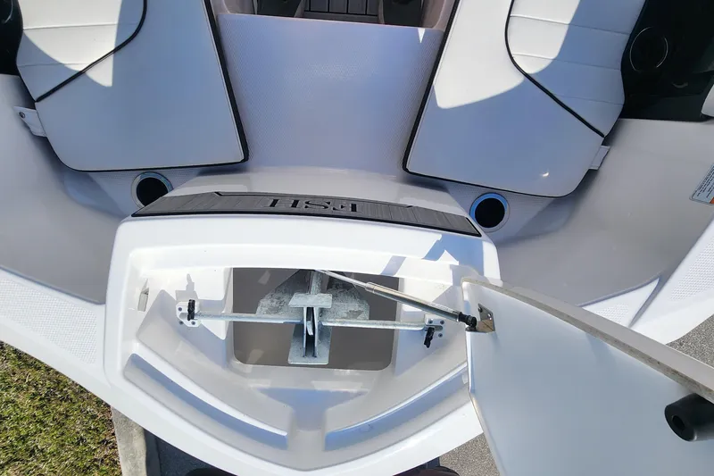 Slide: The Image of 2022 Yamaha 255 FSH Sport E boat anchor storage compartment open. - 31