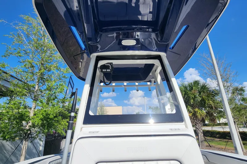 Slide: The Image of 2022 Yamaha 255 FSH Sport E boat with blue canopy, viewed from below. - 33