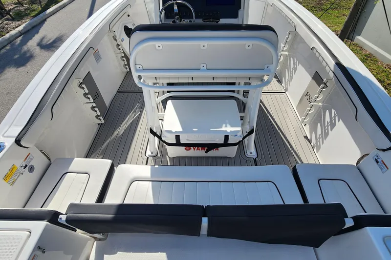 Slide: The Image of 2022 Yamaha 255 FSH Sport E boat interior with seating and steering console. - 37