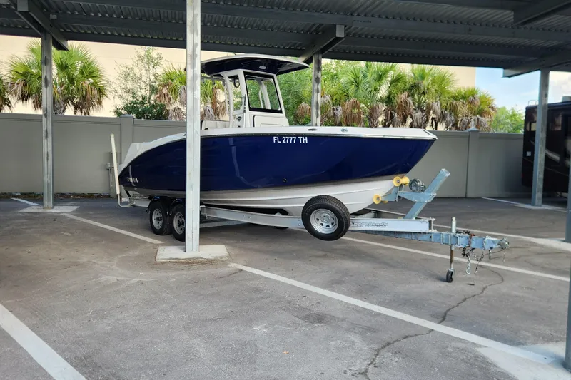 Slide: The Image of 2022 Yamaha 255 FSH Sport E boat on trailer in covered parking area. - 44