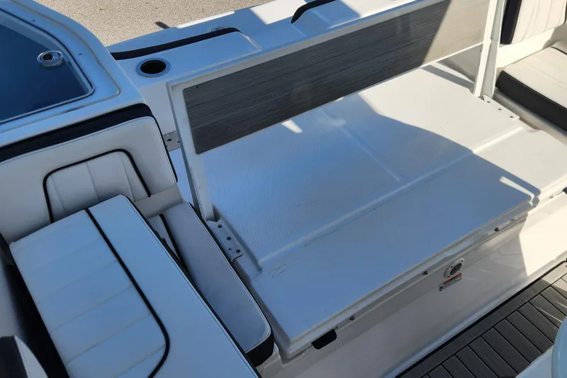 Slide: The Image of 2022 Yamaha 255 FSH Sport E boat interior with seating and storage area. - 5