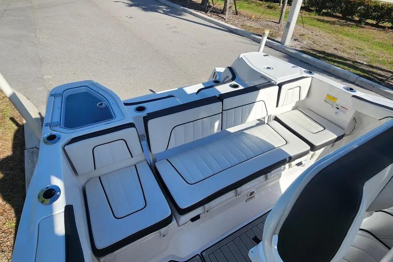 Slide: The Image of 2022 Yamaha 255 FSH Sport E boat interior with sleek seating and storage compartments. - 7