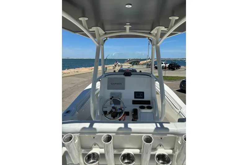 Slide: The Image of 2019 Regulator 23 boat dashboard with Garmin navigation, docked by the sea. - 10