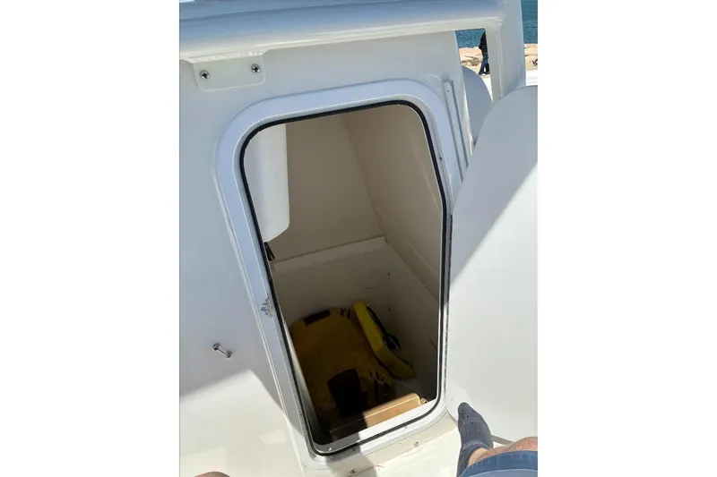 Slide: The Image of Open hatch on 2019 Regulator 23 boat, revealing interior storage space. - 12