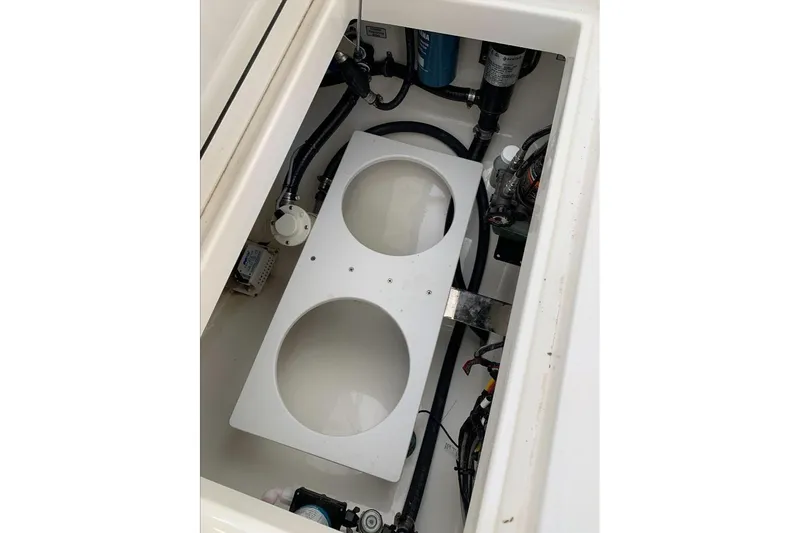 Slide: The Image of 2019 Regulator 23 boat compartment with wiring and components visible. - 13