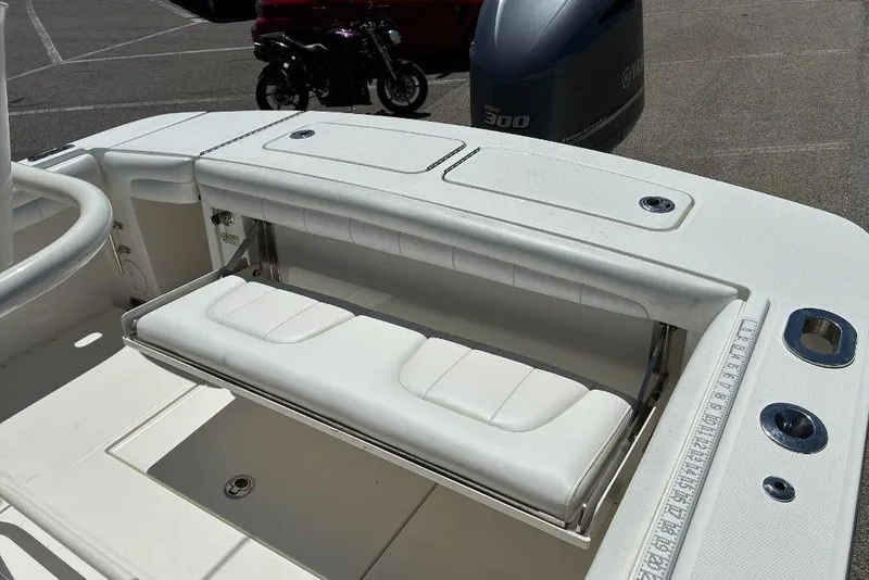 Slide: The Image of 2019 Regulator 23 boat with white seating and Yamaha 300 engine in parking lot. - 15