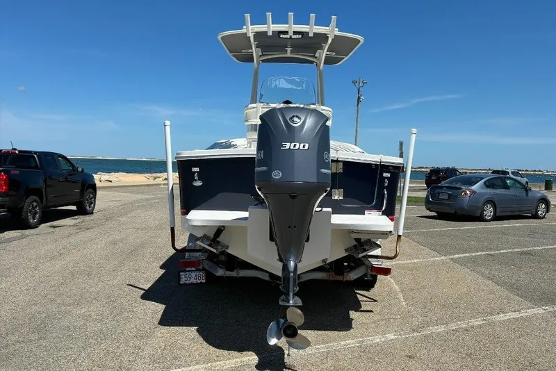 Slide: The Image of 2019 Regulator 23 boat with Yamaha 300 engine at a coastal parking area. - 2