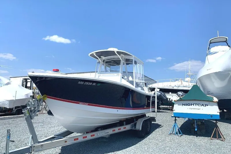 Slide: The Image of 2019 Regulator 23 boat on trailer under clear blue sky. - 5