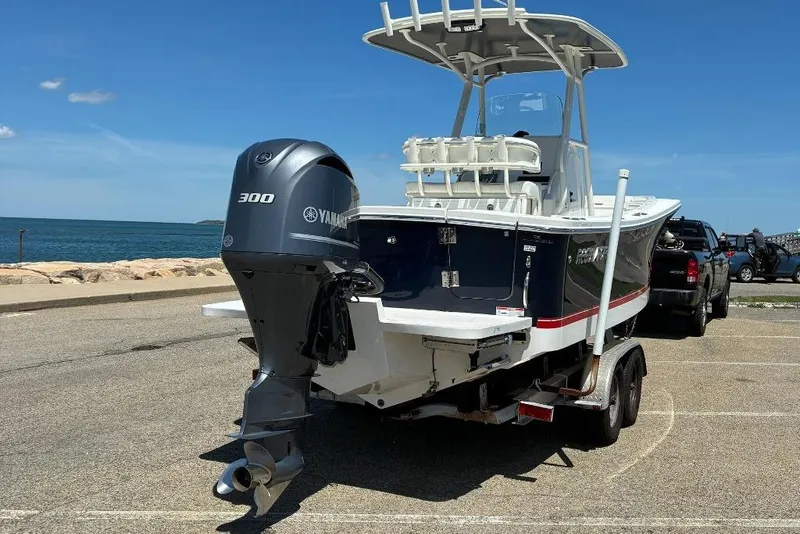 Slide: The Image of 2019 Regulator 23 boat with Yamaha 300 engine on trailer by the sea. - 6