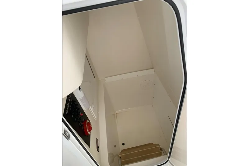 Slide: The Image of 2019 Regulator 23 boat interior cabin with control panel and steps. - 8