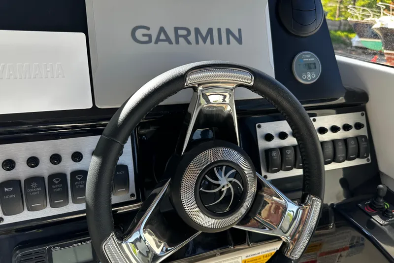 Slide: The Image of Steering wheel and dashboard of 2026 Solara S-250 Coupe with Garmin navigation system. - 12