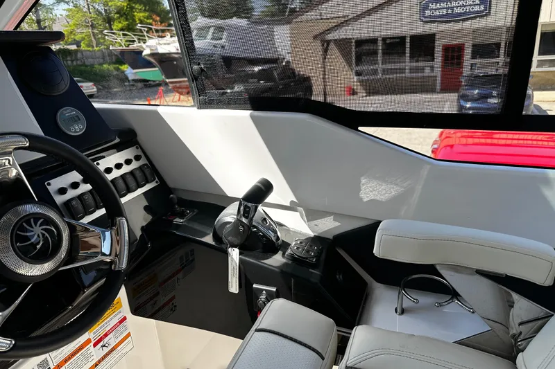 Slide: The Image of Interior of 2026 Solara S-250 Coupe boat with steering wheel and control panel. - 13