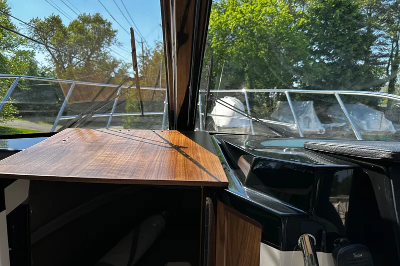 Slide: The Image of Interior view of 2026 Solara S-250 Coupe boat with wooden dashboard and clear windshield. - 23