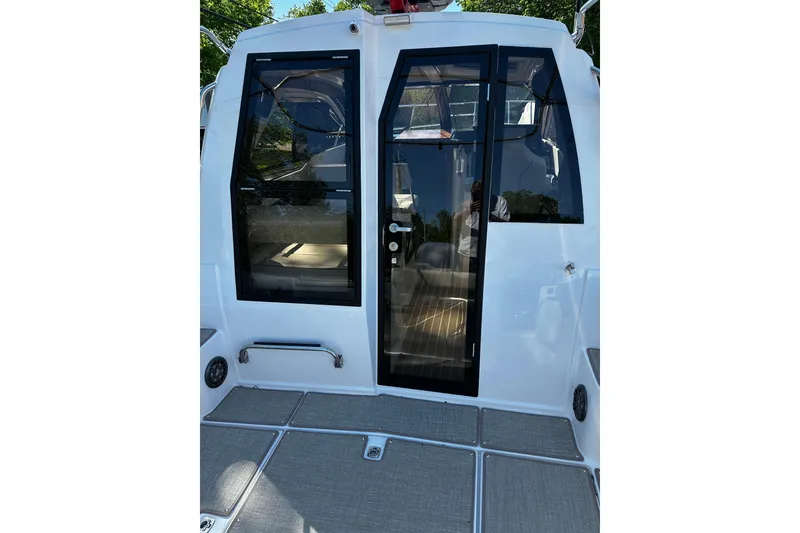 Slide: The Image of 2026 Solara S-250 Coupe boat with sleek glass doors and modern design. - 6