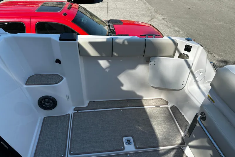 Slide: The Image of Interior of 2026 Solara S-250 Coupe with seating and speaker, parked beside a red vehicle. - 8