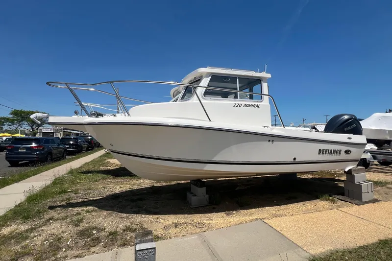The Image of 2026 Defiance Admiral 220 EX boat displayed outdoors on a sunny day. - 6