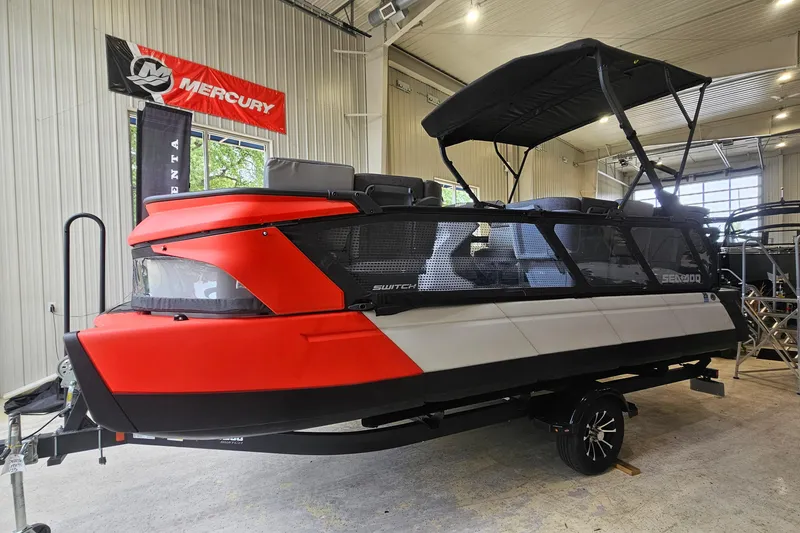 The Image of 2023 Sea-Doo Switch Cruise 21 pontoon boat in showroom, featuring sleek design and vibrant colors. - 1