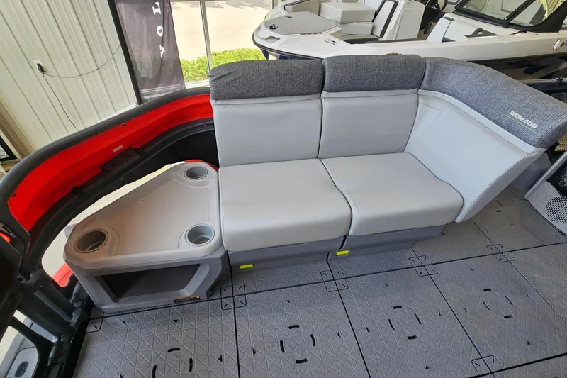 Slide: The Image of 2023 Sea-Doo Switch Cruise 21 interior seating with cup holders and modern design. - 13
