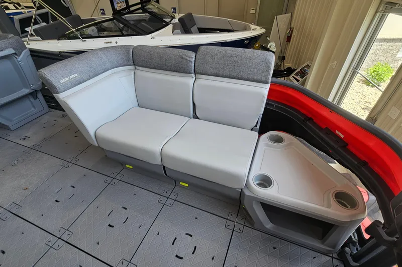 Slide: The Image of 2023 Sea-Doo Switch Cruise 21 interior with gray seating and cup holders. - 14