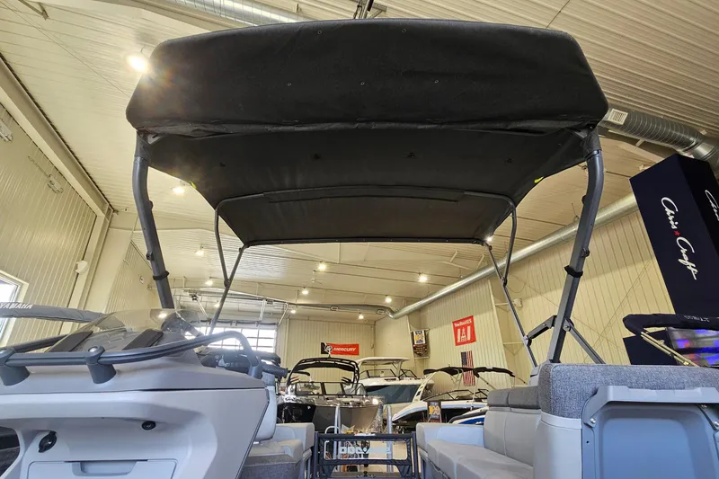 Slide: The Image of 2023 Sea-Doo Switch Cruise 21 boat interior with canopy in showroom setting. - 15