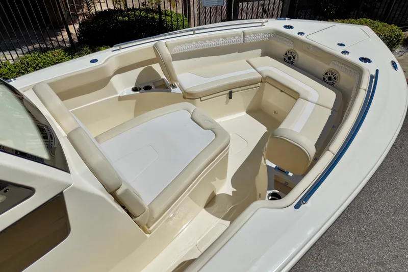 Slide: The Image of 2026 Scout 260 LXF boat interior with cushioned seating and cup holders. - 10