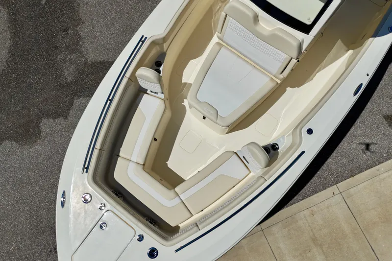 Slide: The Image of 2026 Scout 260 LXF boat interior with beige seating and sleek design. - 11