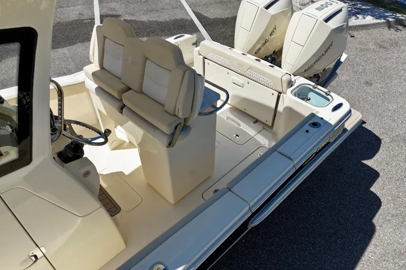 Slide: The Image of 2026 Scout 260 LXF boat interior with dual Mercury engines and seating. - 12