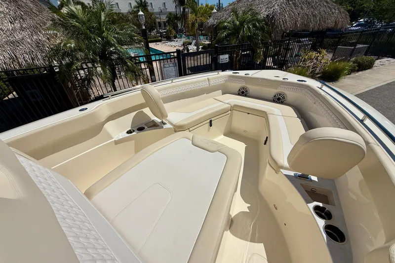 Slide: The Image of 2026 Scout 260 LXF boat interior with luxurious seating and cup holders. - 16