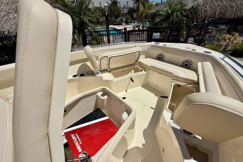 Slide: The Image of 2026 Scout 260 LXF boat interior with open storage compartments and seating. - 17
