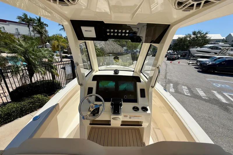 Slide: The Image of 2026 Scout 260 LXF boat cockpit with modern controls and steering wheel. - 18