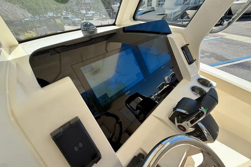 Slide: The Image of Helm of 2026 Scout 260 LXF boat with modern navigation system and controls. - 19