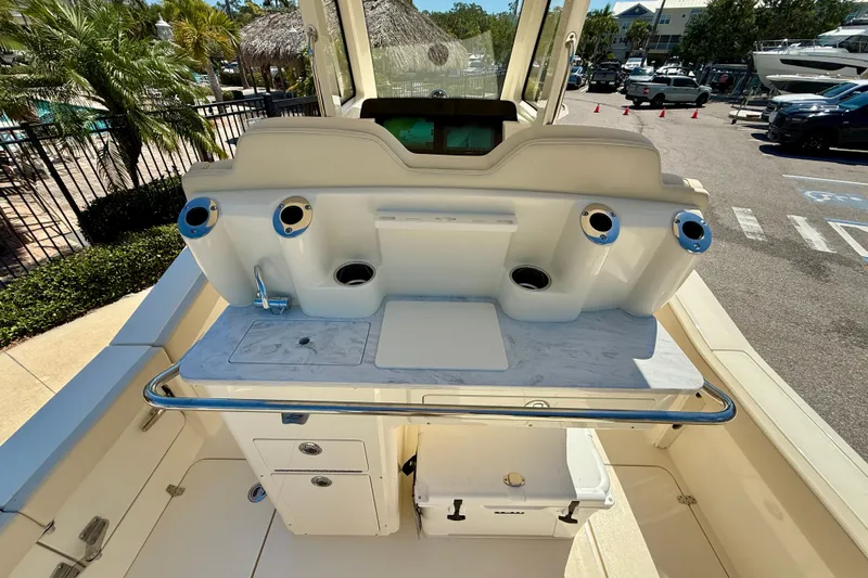 Slide: The Image of 2026 Scout 260 LXF boat interior with fishing rod holders and storage compartments. - 22