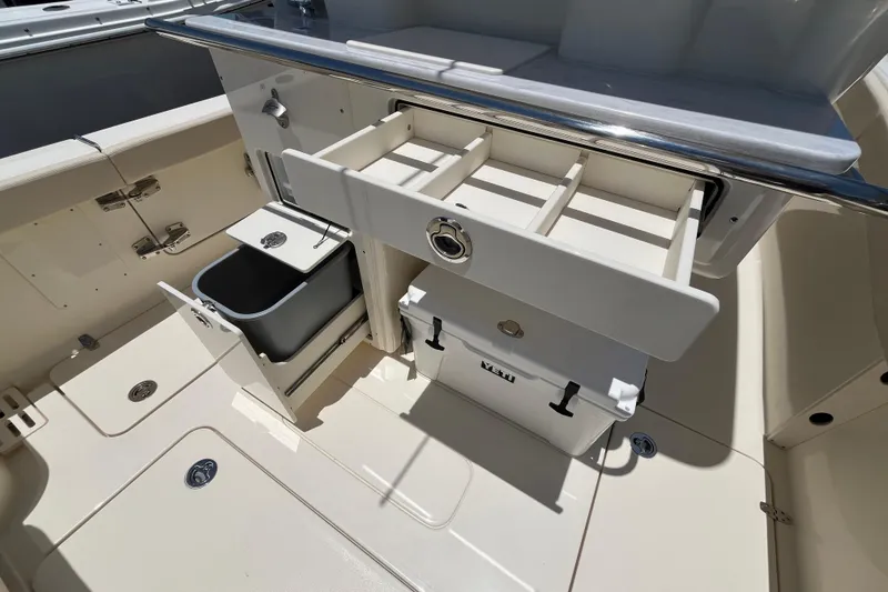 Slide: The Image of 2026 Scout 260 LXF boat interior with storage compartments and cooler. - 23