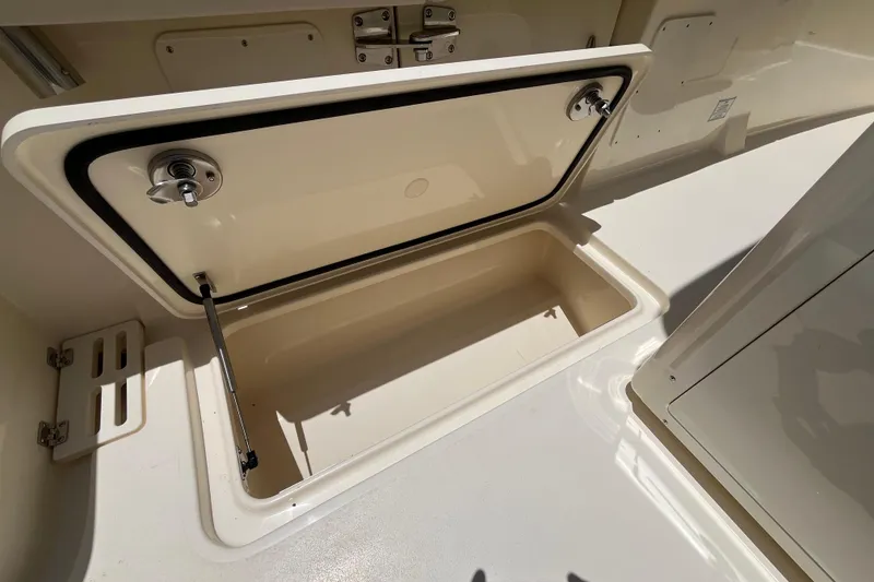 Slide: The Image of Open storage compartment on 2026 Scout 260 LXF boat, showcasing interior space. - 26