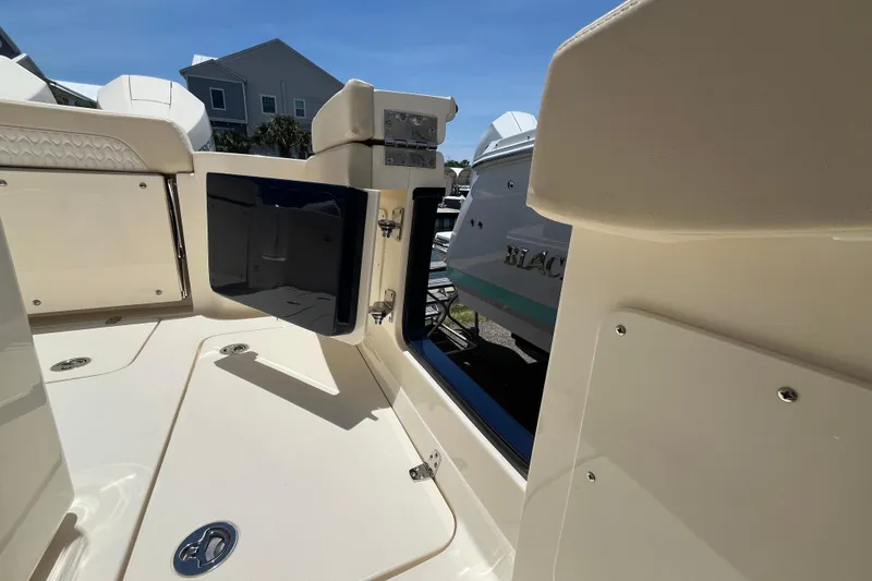 Slide: The Image of 2026 Scout 260 LXF boat interior with open storage compartment, showcasing sleek design. - 29
