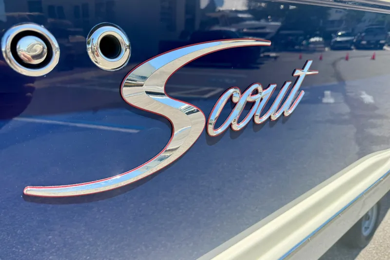 Slide: The Image of Close-up of 2026 Scout 260 LXF logo on a blue boat exterior. - 30