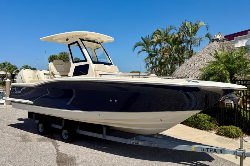 Slide: The Image of 2026 Scout 260 LXF boat on trailer, surrounded by tropical plants. - 4