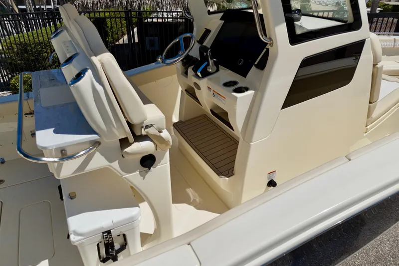 Slide: The Image of 2026 Scout 260 LXF boat interior with helm, seating, and control panel. - 7