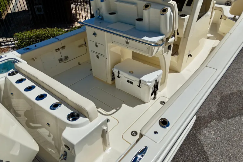 Slide: The Image of 2026 Scout 260 LXF boat interior with seating, storage, and cooler. - 9