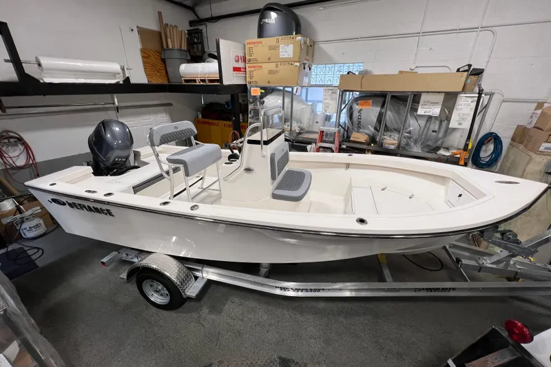 The Image of 2026 Defiance Catalina 190 boat in a garage, on a trailer, with Yamaha outboard motor. - 0
