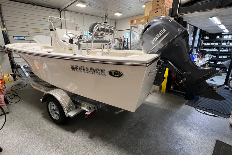 Slide: The Image of 2026 Defiance Catalina 190 boat with Yamaha engine in a workshop setting. - 1