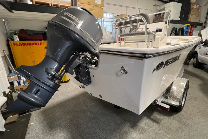 Slide: The Image of 2026 Defiance Catalina 190 boat with Yamaha outboard motor in a garage setting. - 2