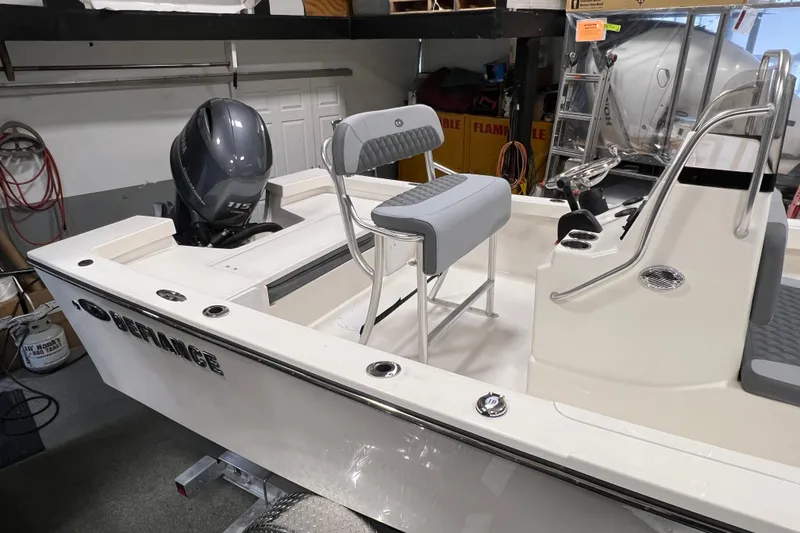 Slide: The Image of 2026 Defiance Catalina 190 boat in garage, featuring sleek design and powerful outboard motor. - 4