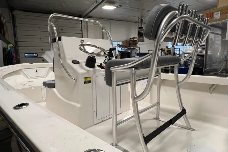 Slide: The Image of 2026 Defiance Catalina 190 boat interior with steering console and seating in a garage setting. - 6