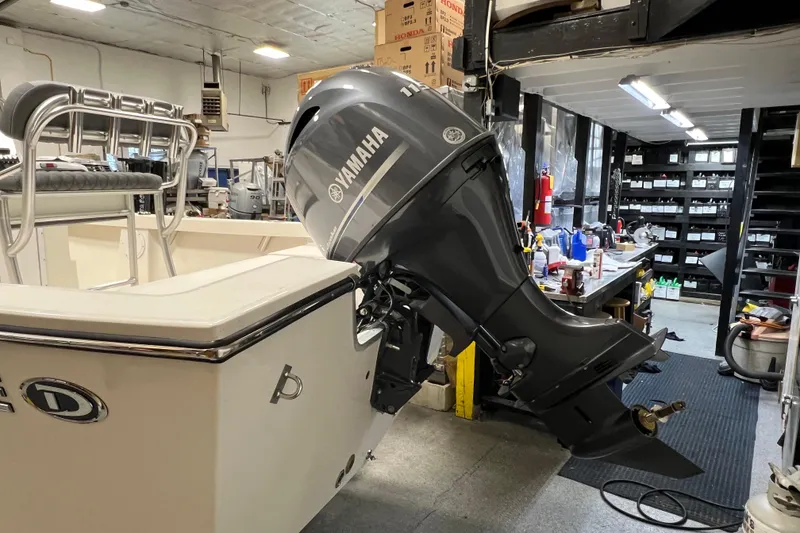 Slide: The Image of 2026 Defiance Catalina 190 boat with Yamaha outboard motor in a workshop setting. - 7