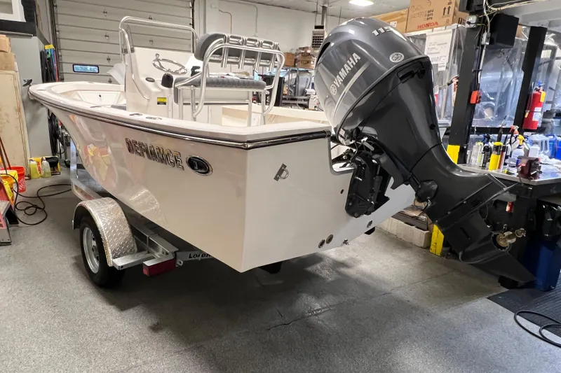 Slide: The Image of 2026 Defiance Catalina 190 boat with Yamaha outboard motor in a workshop setting. - 8