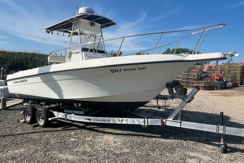 The Image of 2000 Hydra-Sports 230 Seahorse CC boat on trailer, parked outdoors. - 1